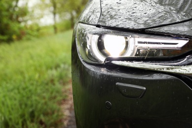 Photo of Car parked outdoors on rainy day, closeup