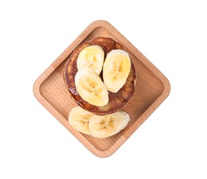 Wooden plate of banana pancakes isolated on white, top view