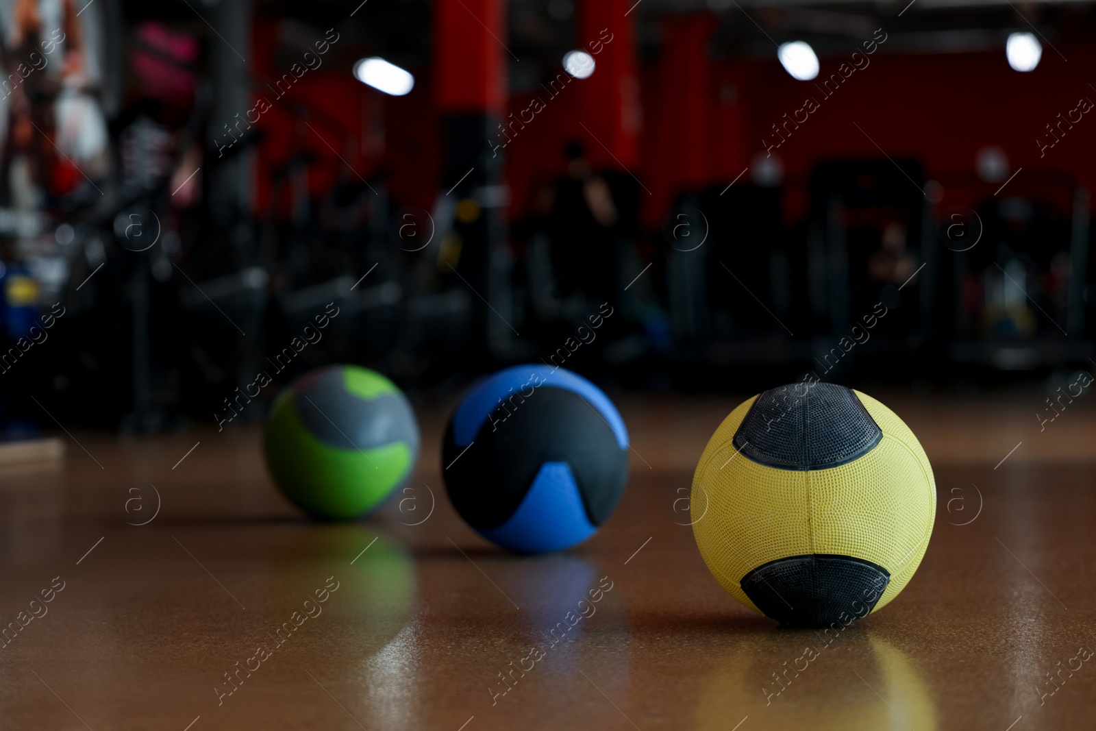 Photo of Medicine balls on floor in gym. Space for text