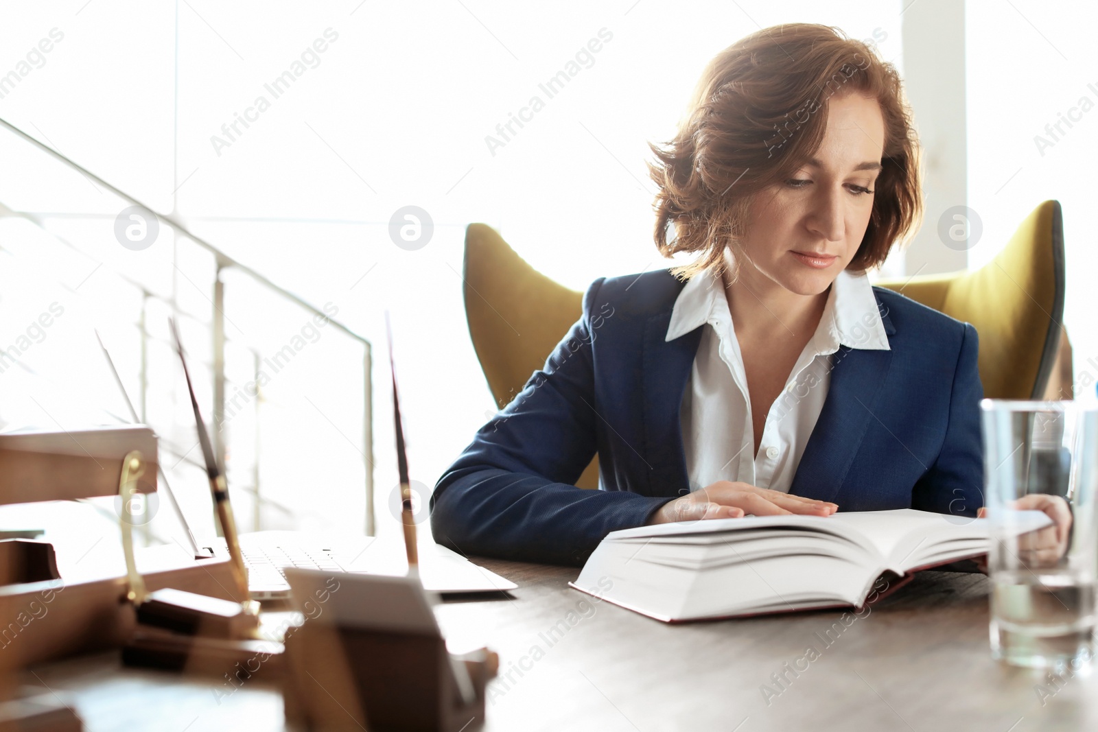 Photo of Female lawyer working at table in office