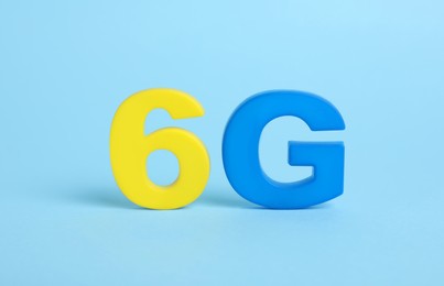 Photo of 6G symbol on light blue background. Modern technologies