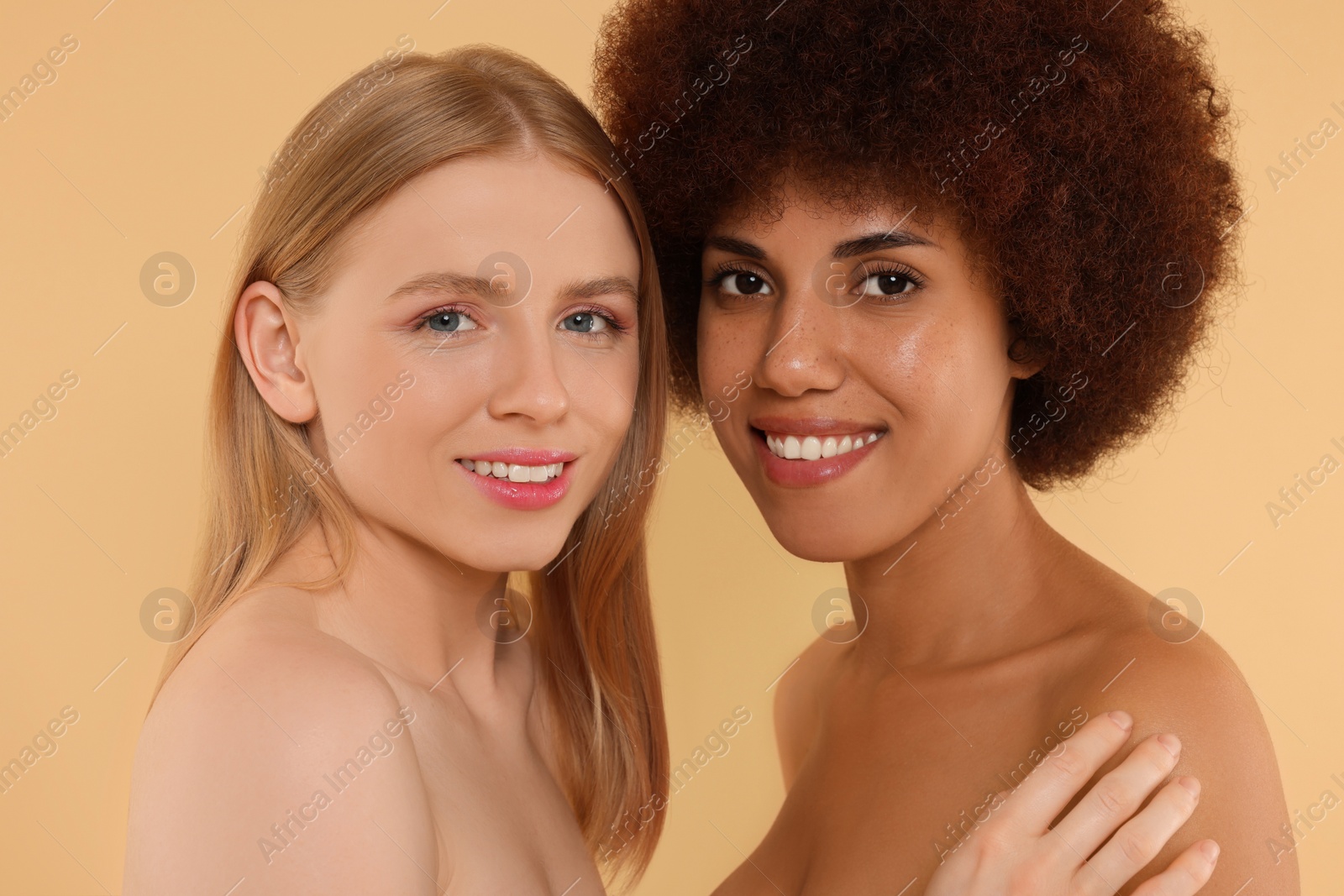 Photo of Portrait of beautiful young women on beige background