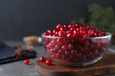 Photo of Fresh ripe cranberries on grey table. Space for text