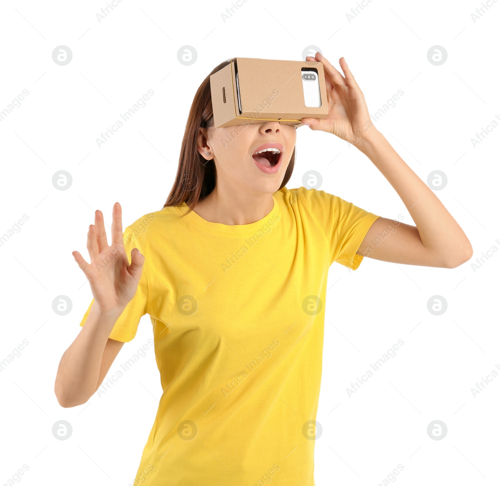 Photo of Young woman using cardboard virtual reality headset, isolated on white