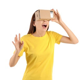 Photo of Young woman using cardboard virtual reality headset, isolated on white