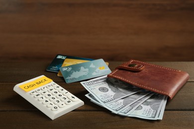 Credit cards, wallet, banknotes and calculator with sign Cash Back on wooden table