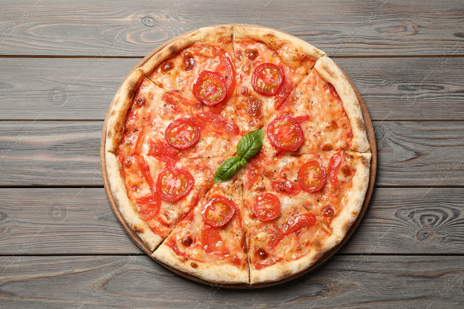 Photo of Delicious pizza Margherita on wooden table, top view