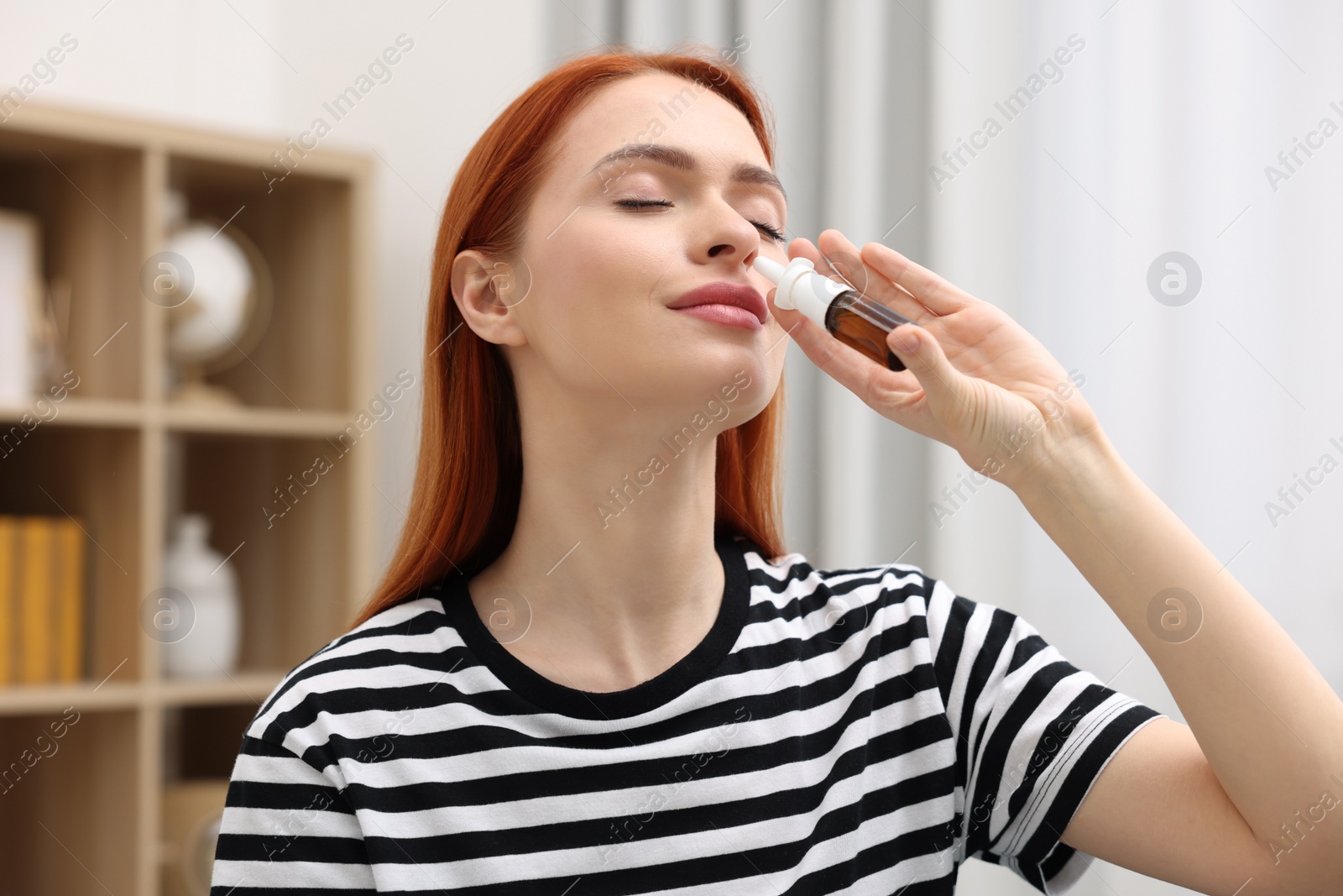 Photo of Medical drops. Woman using nasal spray at home