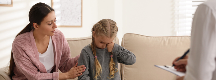 Image of Little girl and her mother on appointment with child psychotherapist indoors. Banner design