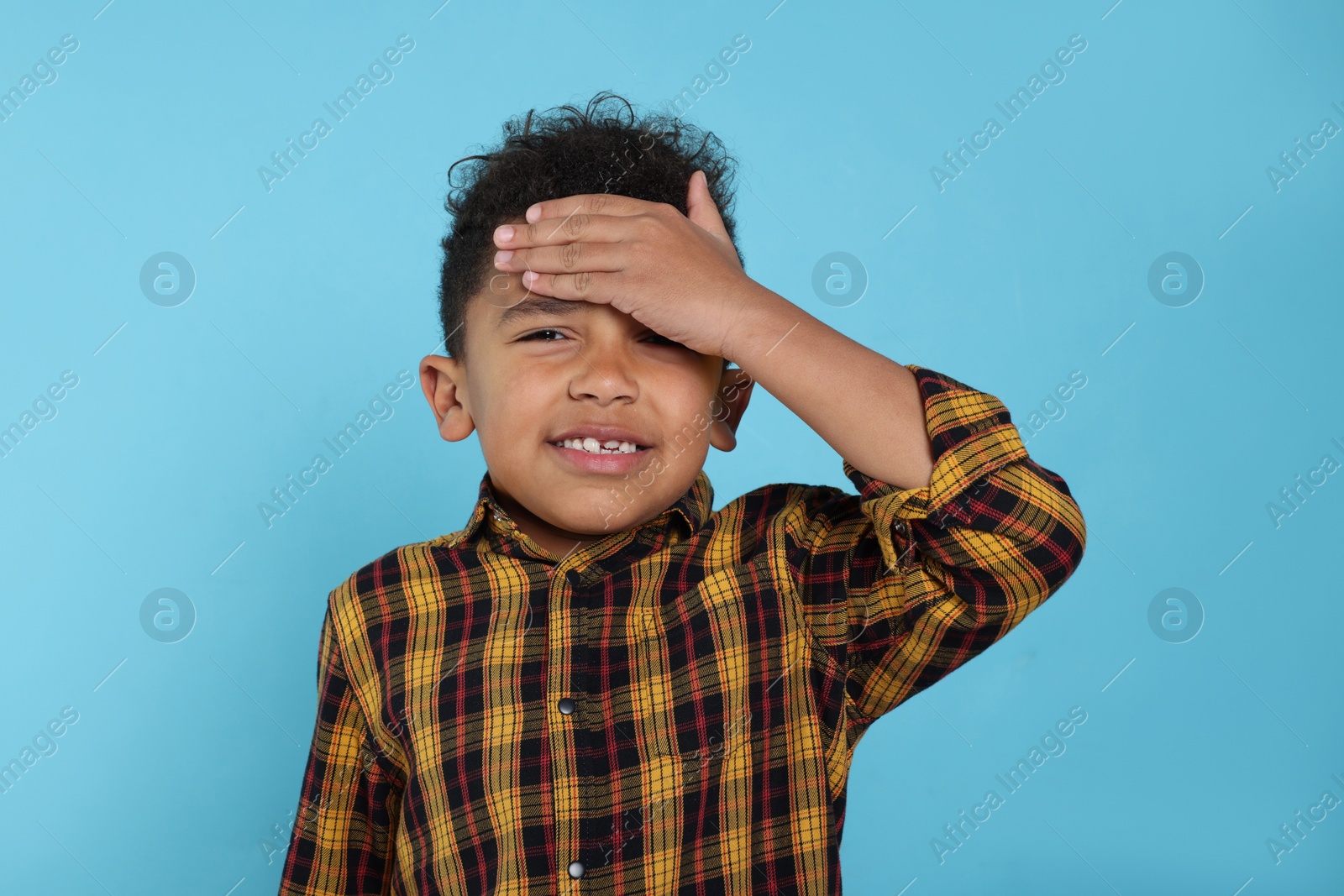 Photo of Portrait of emotional African-American boy on turquoise background