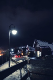 Photo of Beautiful view of mountain village street at night in winter