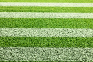 Image of Green grass with white markings, closeup view