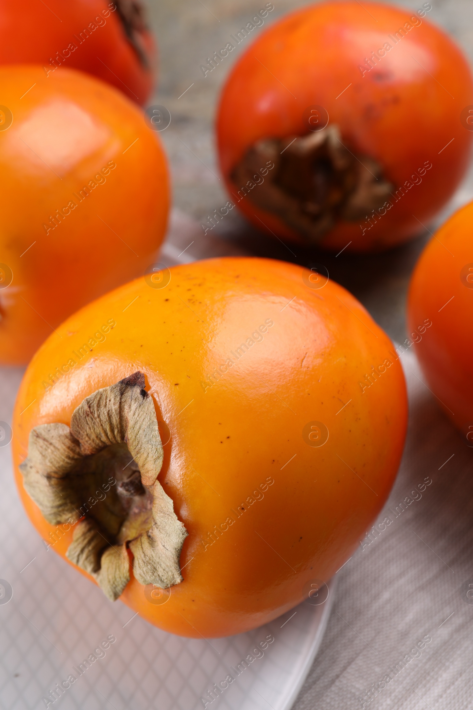 Photo of Delicious ripe persimmons on table, closeup view