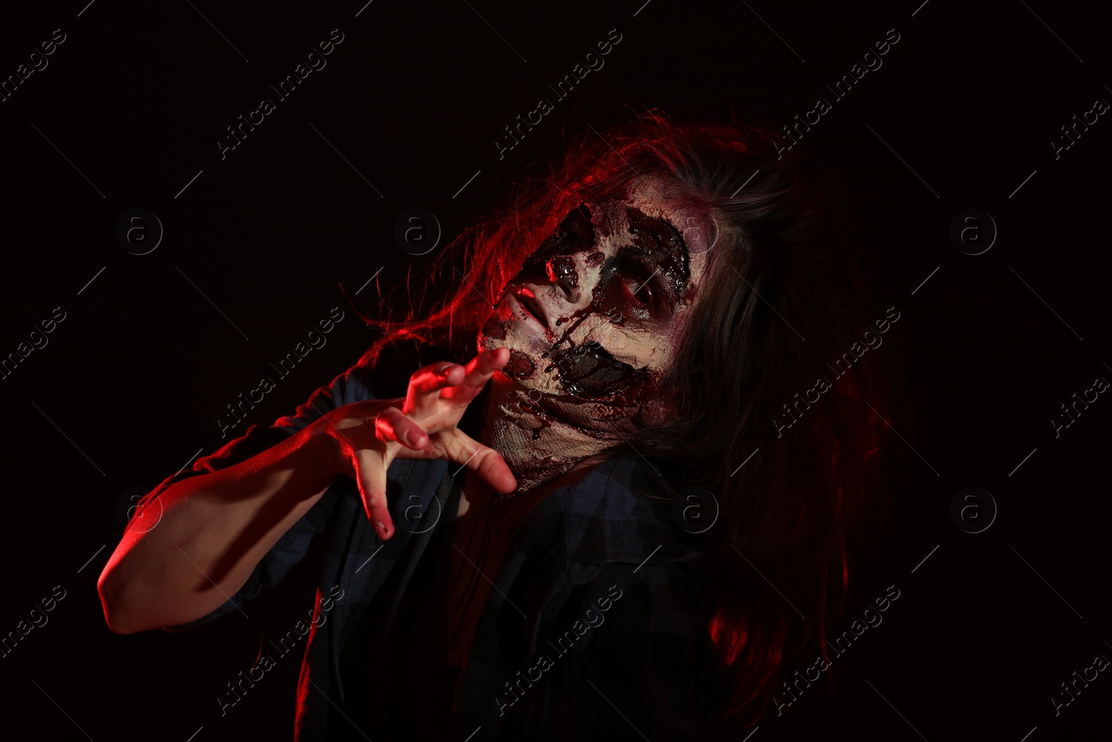 Photo of Scary zombie on dark background. Halloween monster