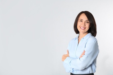 Photo of Portrait of mature businesswoman on white background. Space for text