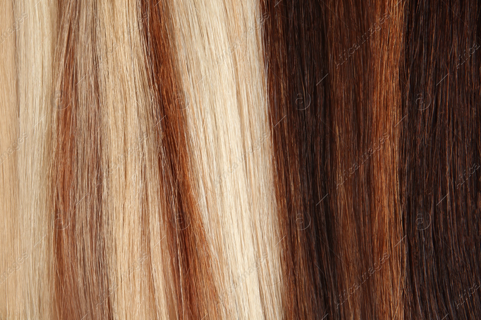 Photo of Strands of different color hair as background, closeup