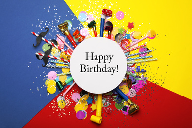 Photo of Flat lay composition with greeting HAPPY BIRTHDAY and party props on color background