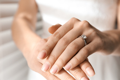 Photo of Young bride wearing beautiful engagement ring, closeup