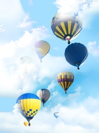 Image of Fantastic dreams. Hot air balloons in blue sky with clouds  