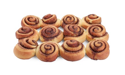 Photo of Many tasty cinnamon rolls isolated on white