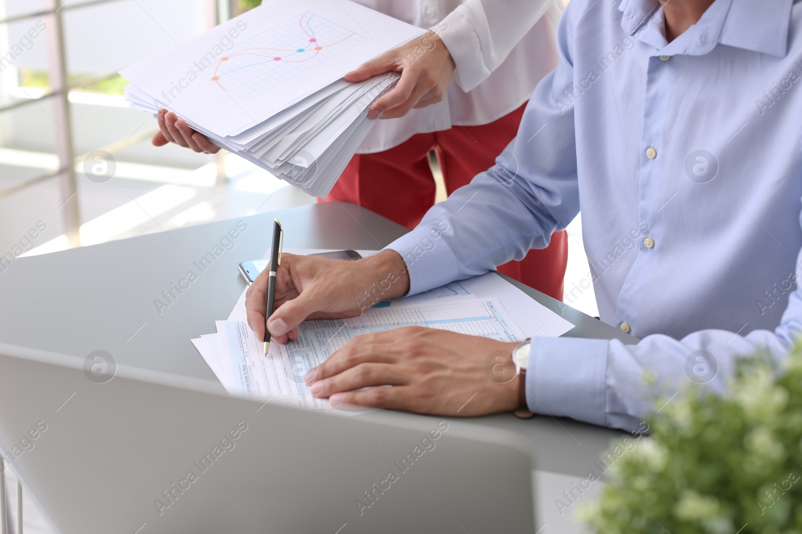 Photo of Tax accountants working with documents at table