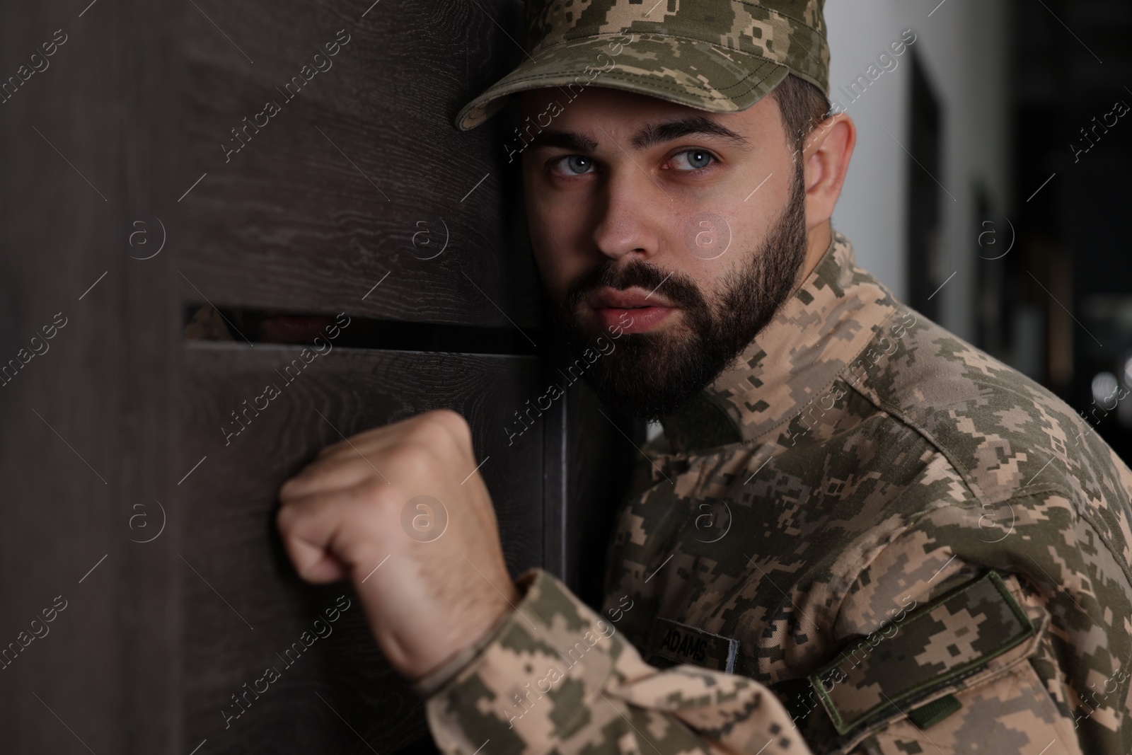 Photo of Military commissariat representative knocking on wooden door