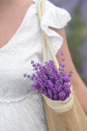 Photo of Woman with bag of beautiful lavender flowers outdoors, closeup