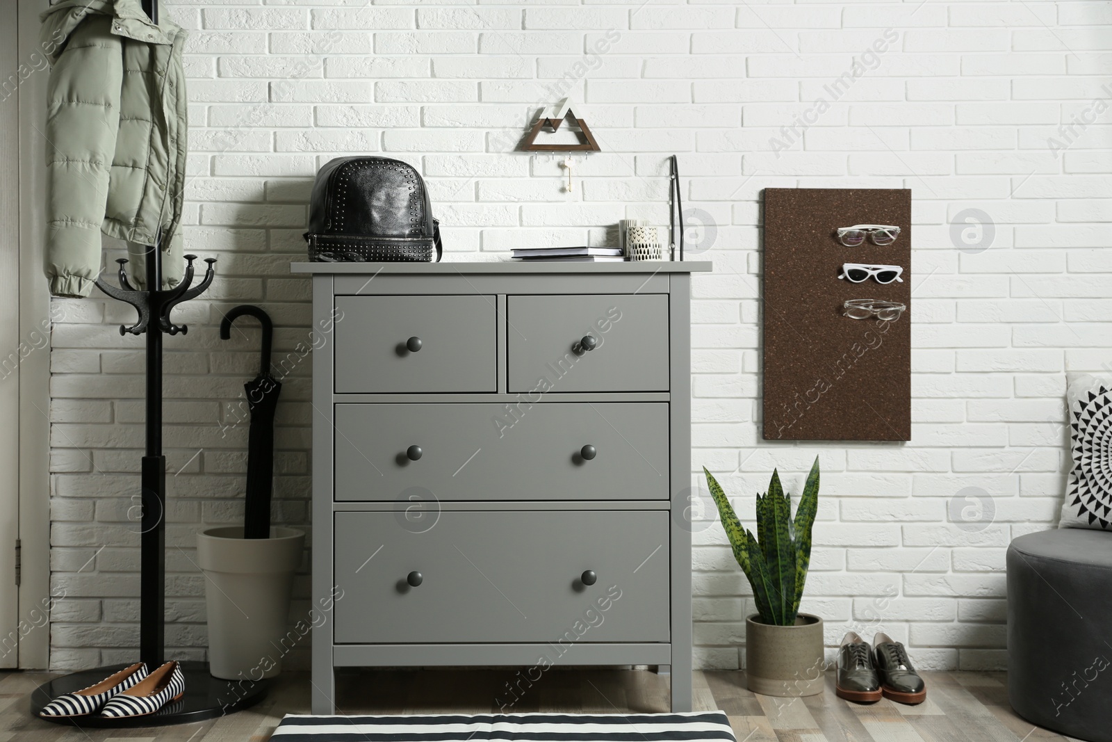 Photo of Grey chest of drawers in stylish hallway interior