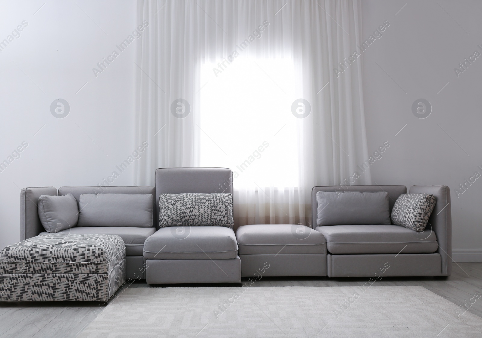 Photo of Simple living room interior with comfortable sofa near window