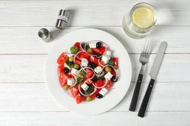 Photo of Plate with delicious salad on table, top view