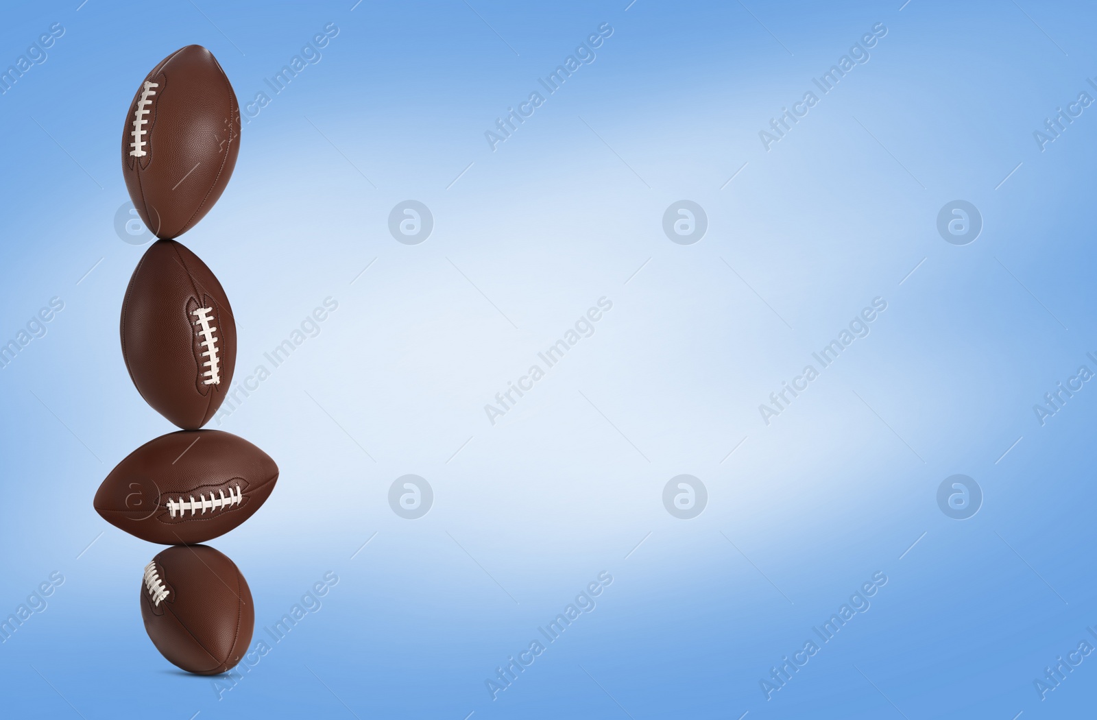 Image of Stack of rugby balls on blue background. Space for text