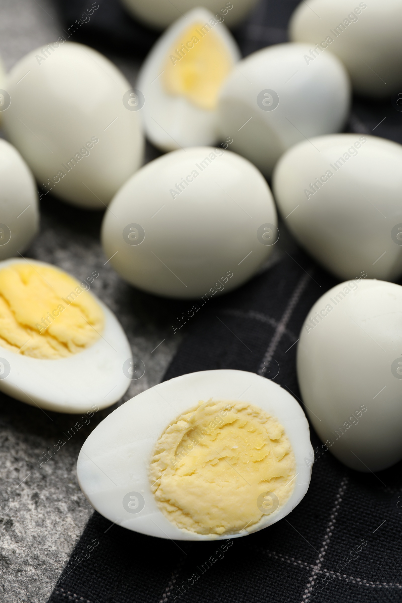 Photo of Peeled hard boiled quail eggs on grey table, closeup