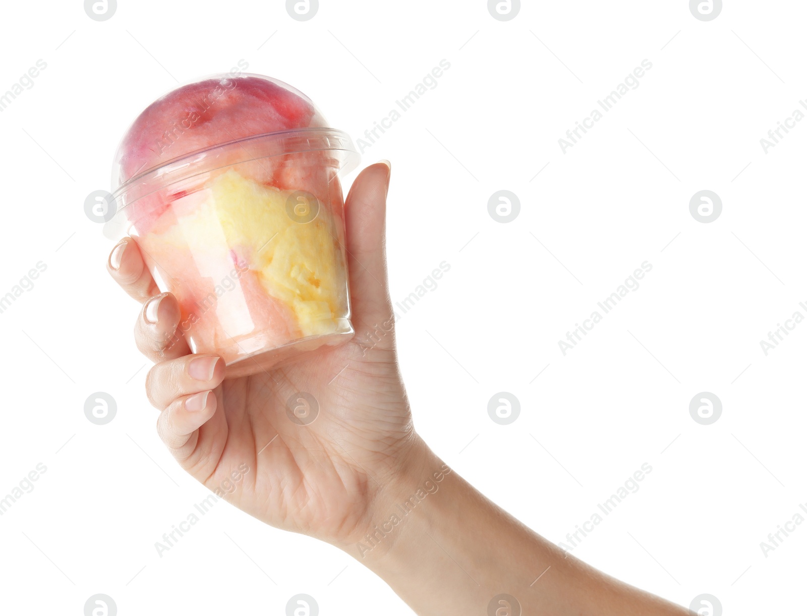 Photo of Woman holding plastic cup with yummy cotton candy on white background, closeup