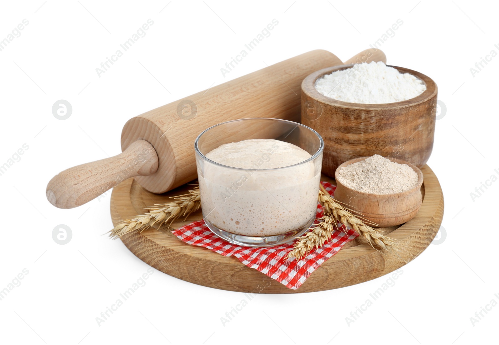 Photo of Leaven, ears of wheat, flour and rolling pin isolated on white