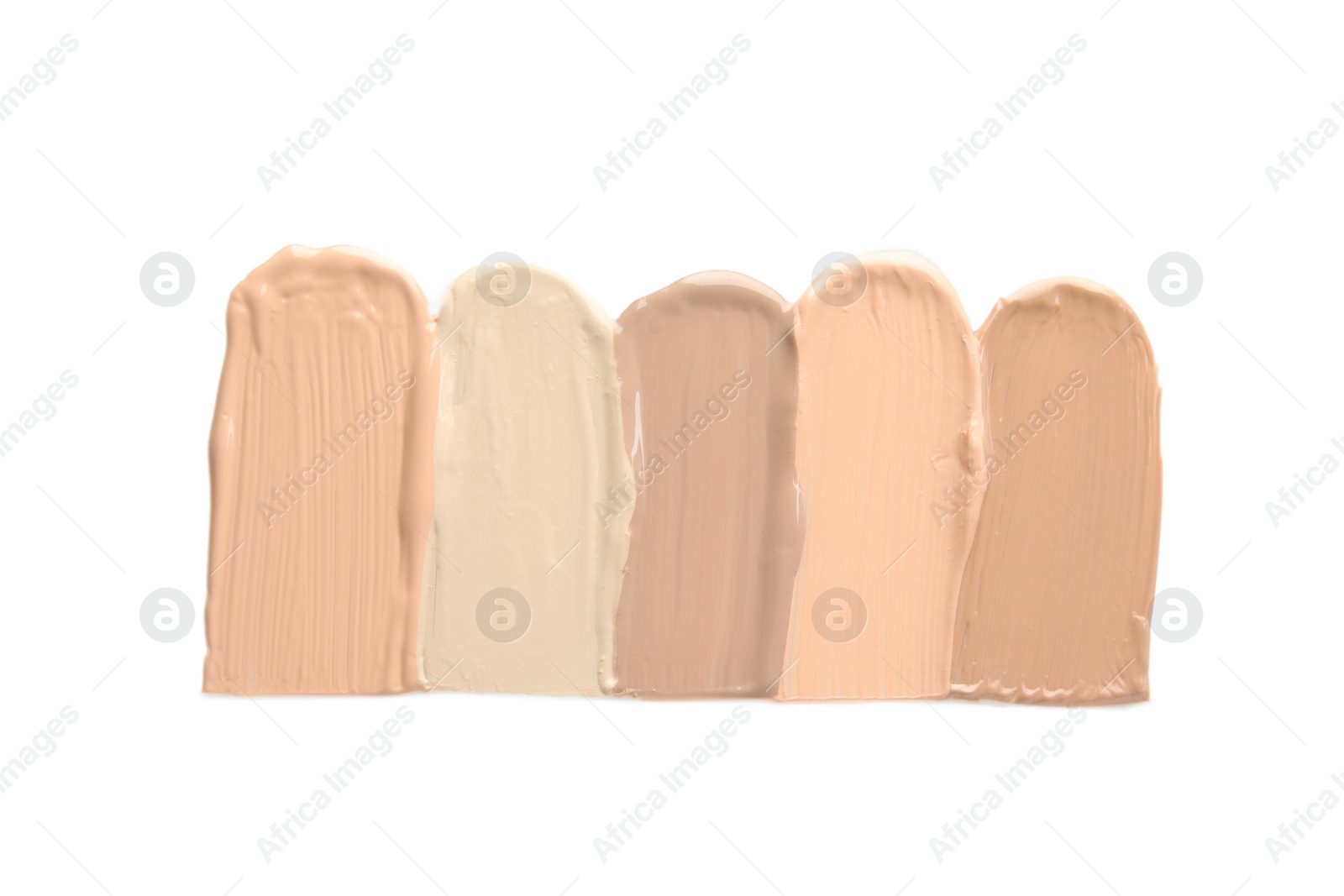 Photo of Samples of different foundation shades on white background, top view