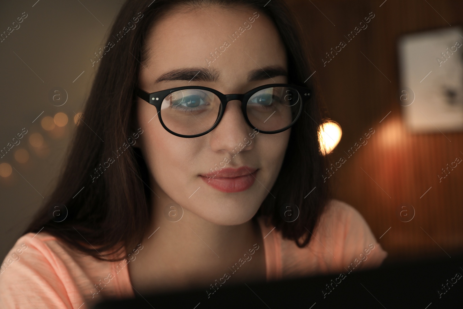 Photo of Beautiful young woman wearing glasses on blurred background. Ophthalmologist service