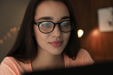 Beautiful young woman wearing glasses on blurred background. Ophthalmologist service