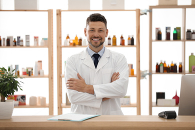 Portrait of happy male pharmacist in drugstore
