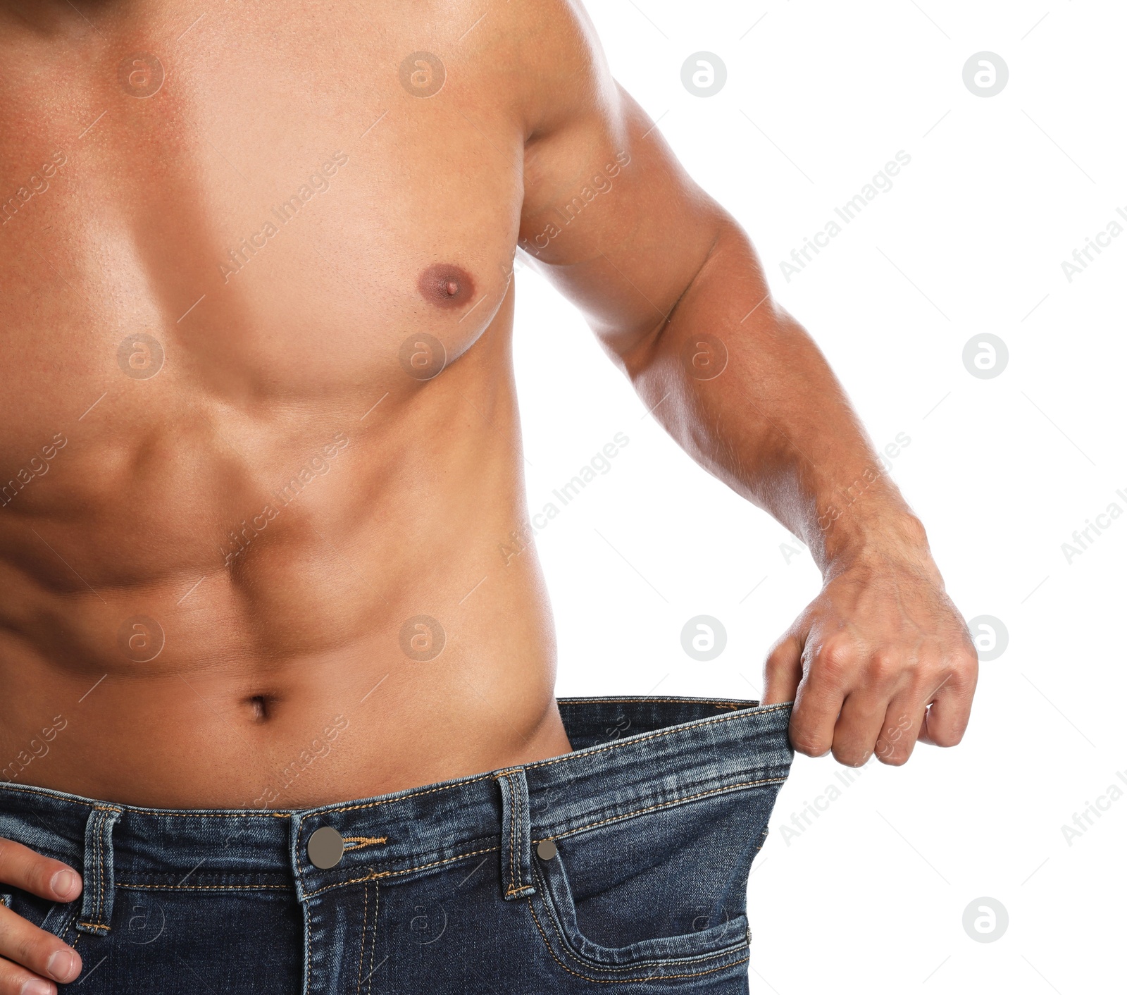 Photo of Young man with slim body in old big size jeans on white background, closeup view