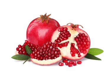 Tasty ripe pomegranates and leaves on white background