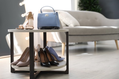 Photo of Stylish women's shoes, belt and bag in modern boutique