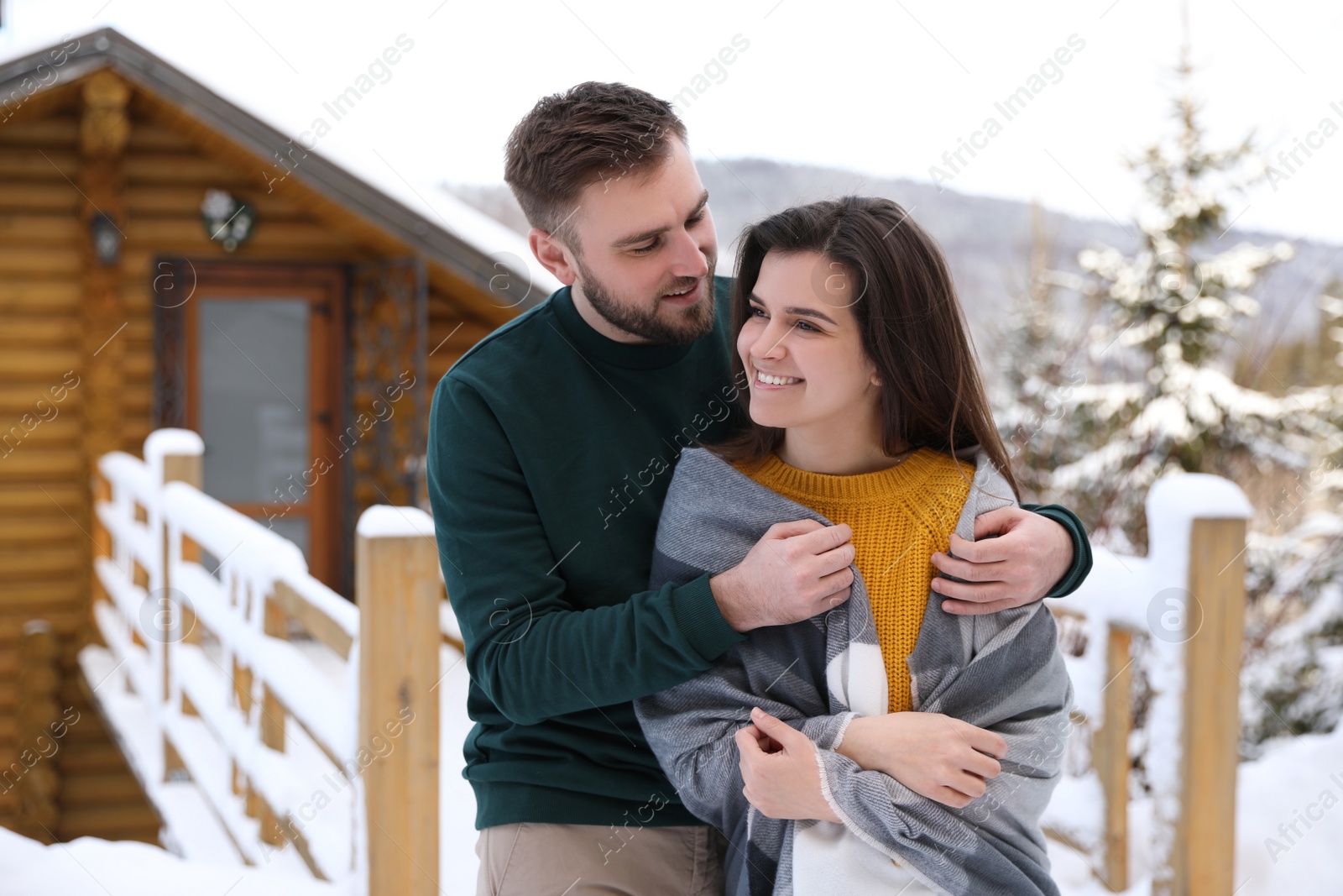 Photo of Lovely couple spending time together on snowy day. Winter vacation