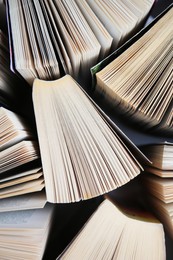 Photo of Collection of different books on white shelf, above view