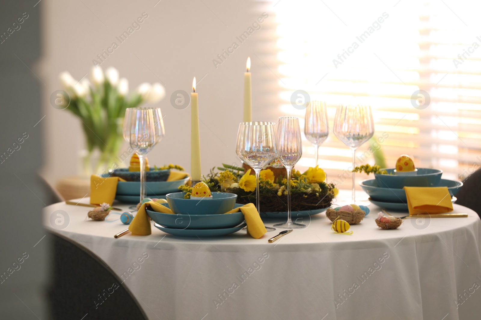 Photo of Festive Easter table setting with beautiful floral decor and eggs indoors