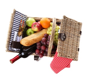 Photo of Wicker picnic basket with wine and different products on white background, top view