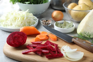 Photo of Fresh ingredients for borscht on light grey table, closeup