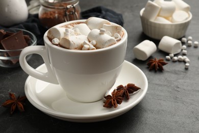 Tasty hot chocolate with marshmallows on dark textured table, closeup