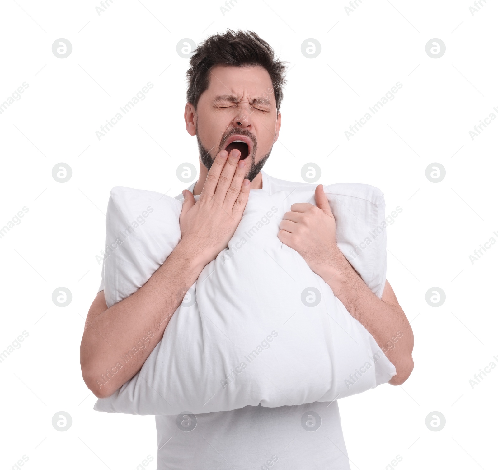 Photo of Tired man with pillow on white background. Insomnia problem