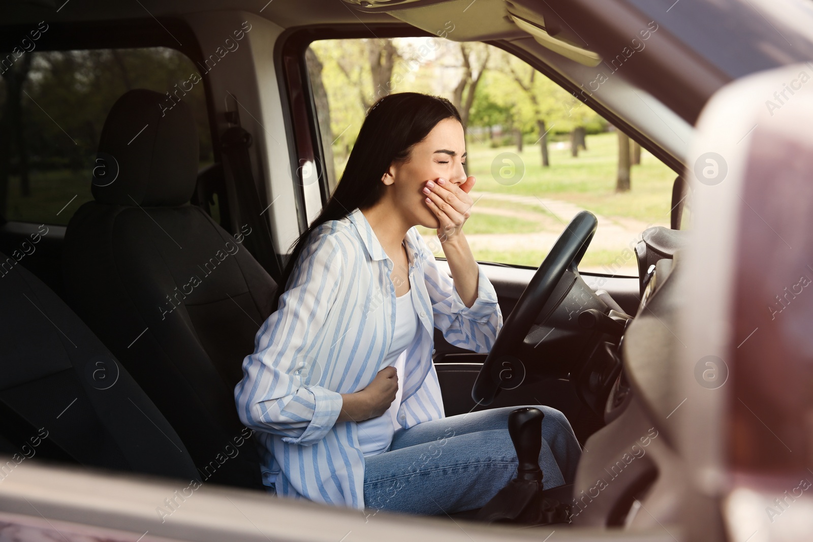 Photo of Young woman suffering from nausea in car