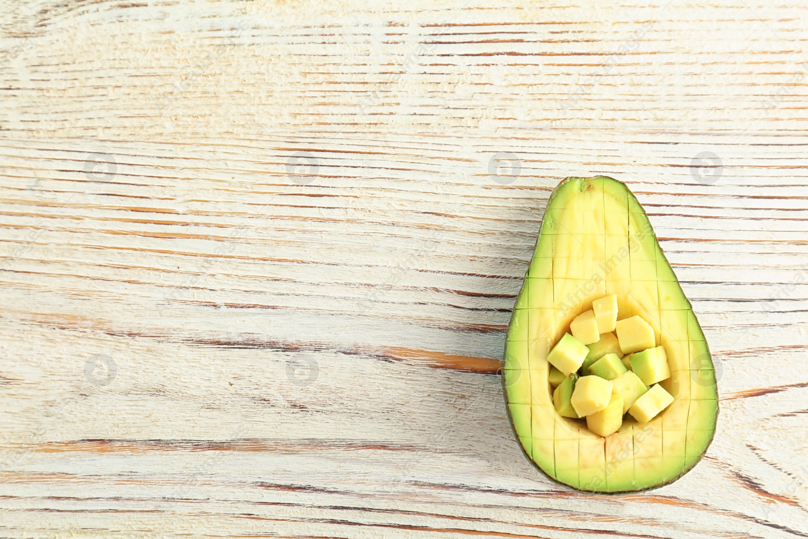 Photo of Cut avocado on wooden background, top view